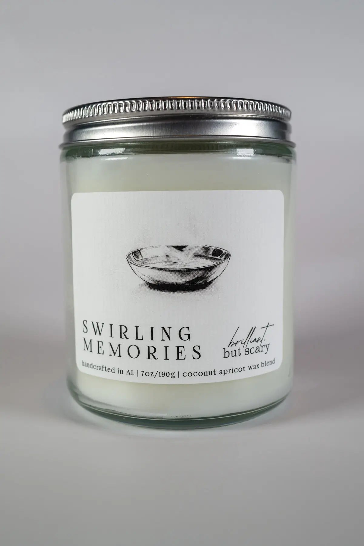 Swirling Memories bookish candle with silver lid and clear glass jar - Brilliant but Scary luxury candles
