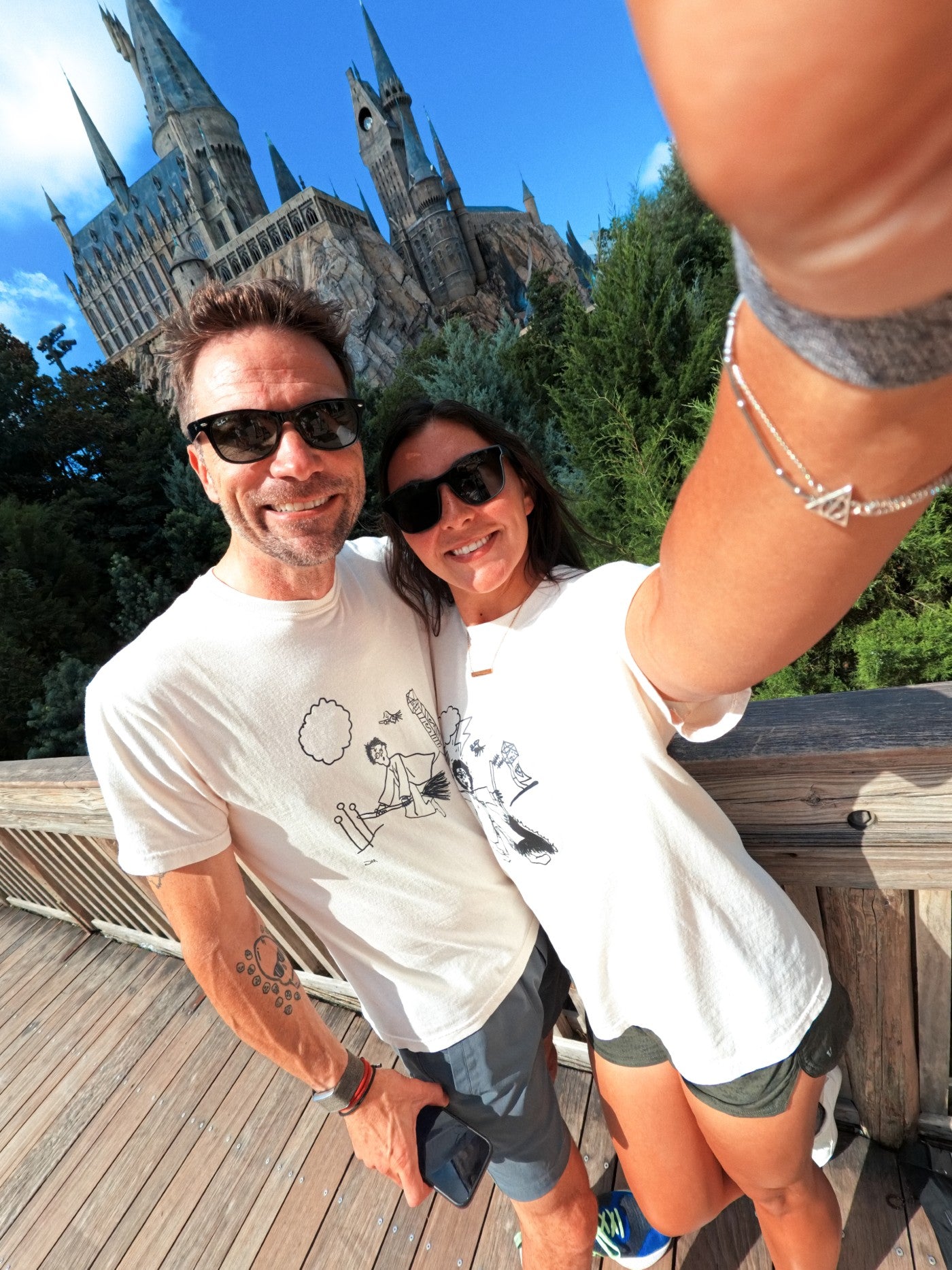 Two Harry Potter fans that created the small business, in front of the Hogwarts Castle at Universal.