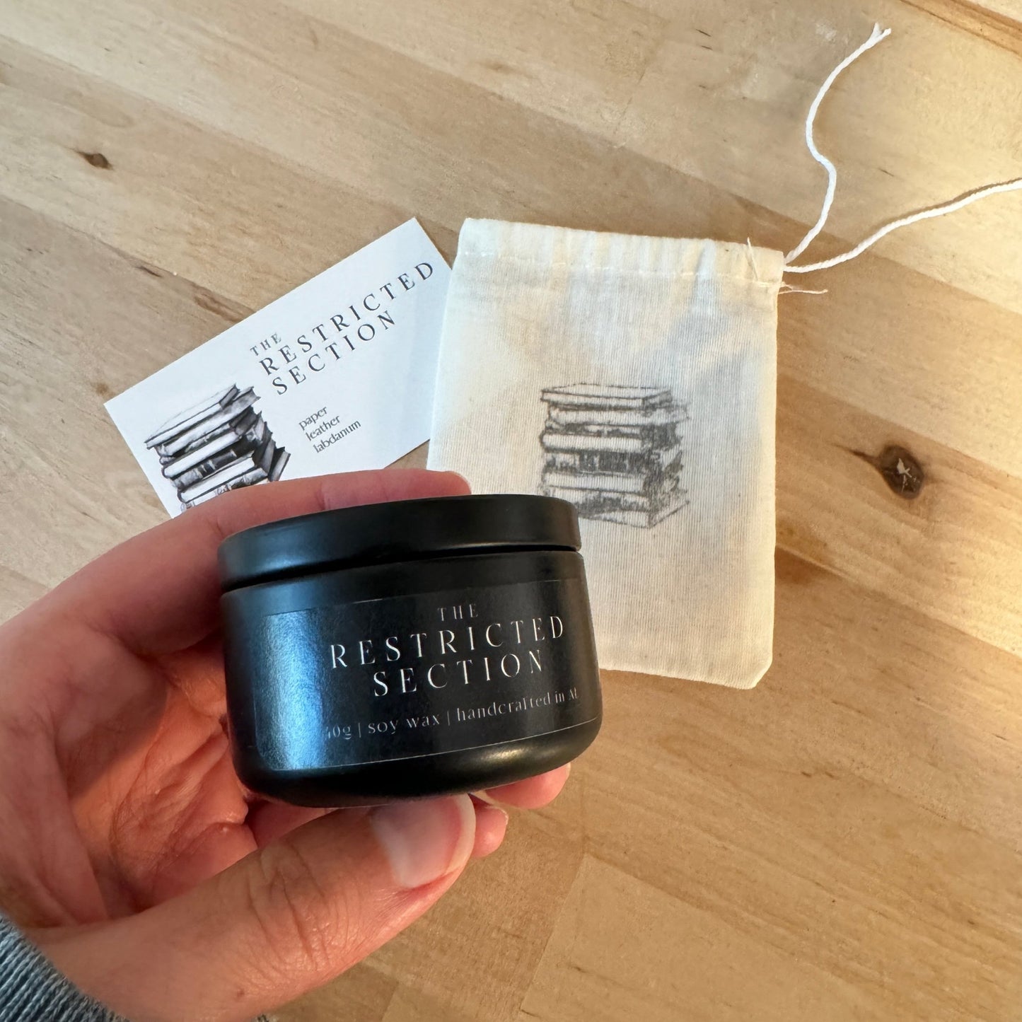 "The Restricted Section" small tin candle in a custom package, a magical handmade gift for Harry Potter fans and book lovers.